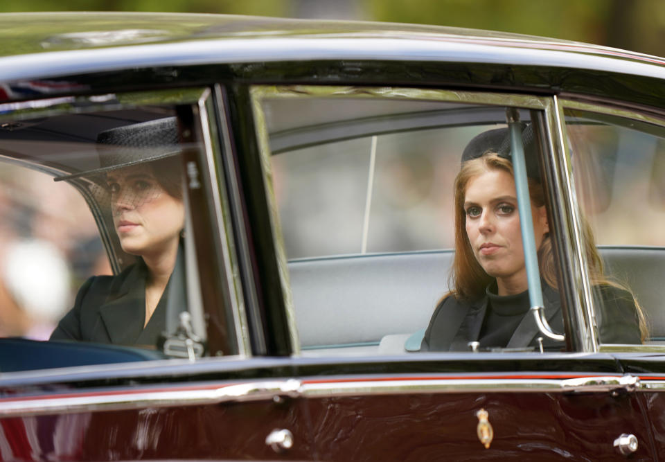 <p>Princess Beatrice, right, and Princess Eugenie depart the Abbey following the Queen's state funeral. (PA)</p> 