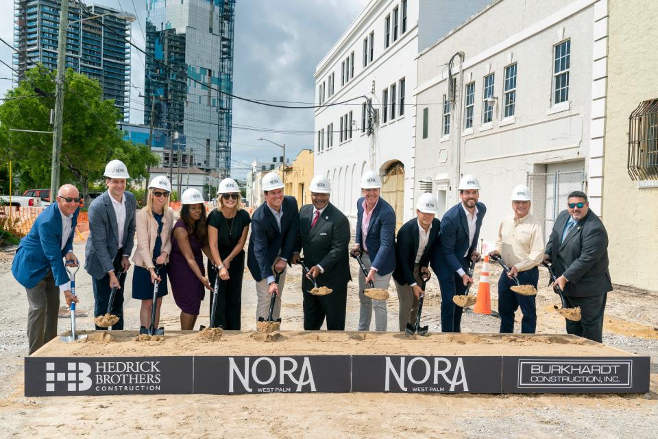 People pose with shovels full of dirt during the groundbreaking ceremony for Nora, the $1 billion dining, business and residential district north of downtown West Palm Beach, Florida on May 31, 2023.