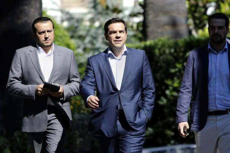 Greek Prime Minister Alexis Tsipras (C) leave the presidential palace after a meeting with party leaders in Athens, on July 6, 2015