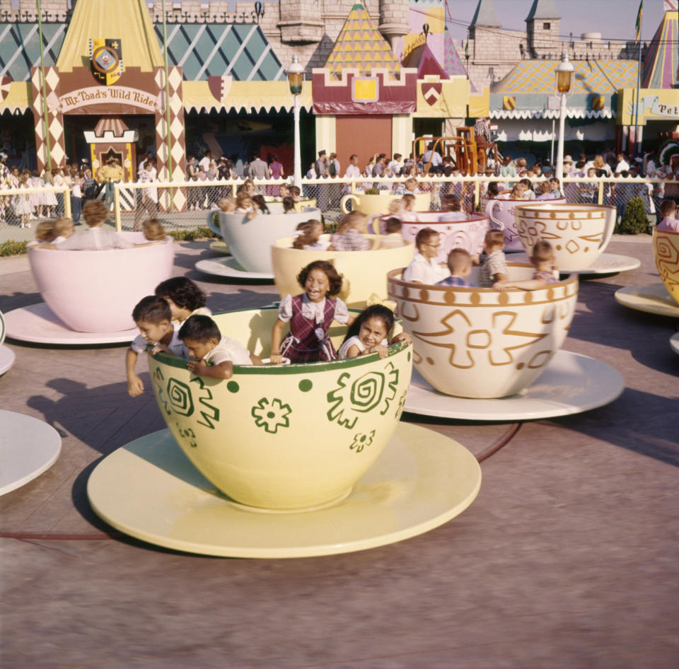 Kids ride the teacups at Disneyland's Mad Tea Party ride in 1955.