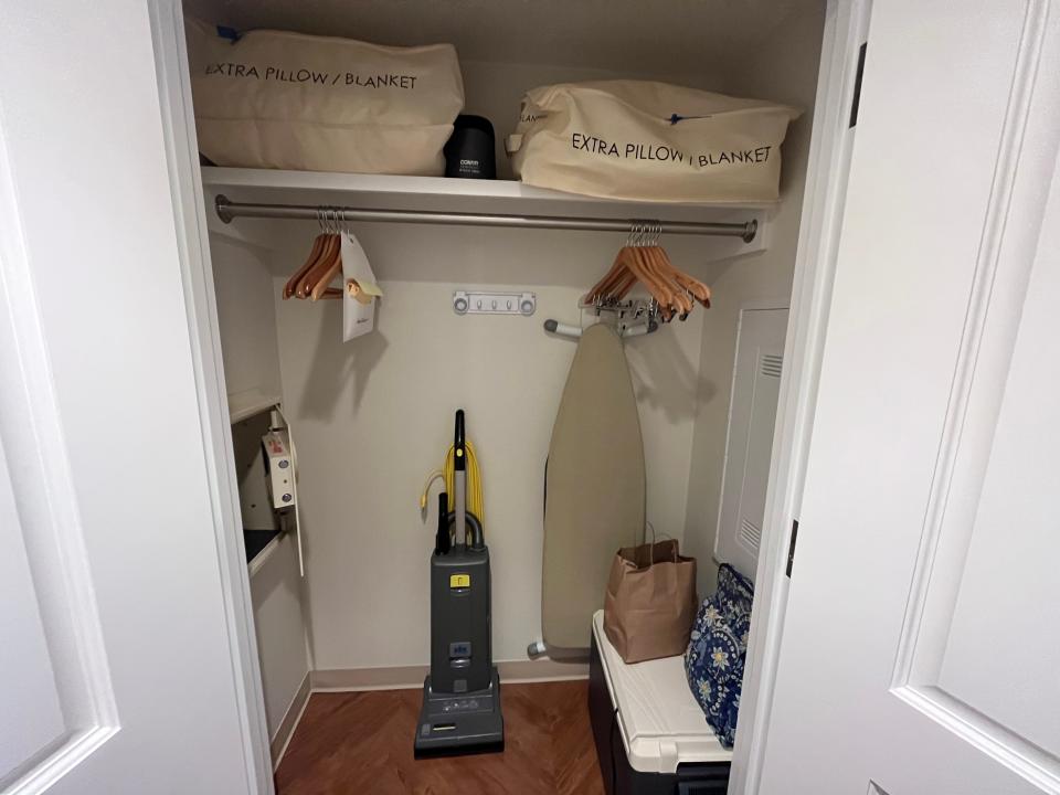 open closet with some storage and cleaning supplies in a one bedroom villa at disney's riviera resort