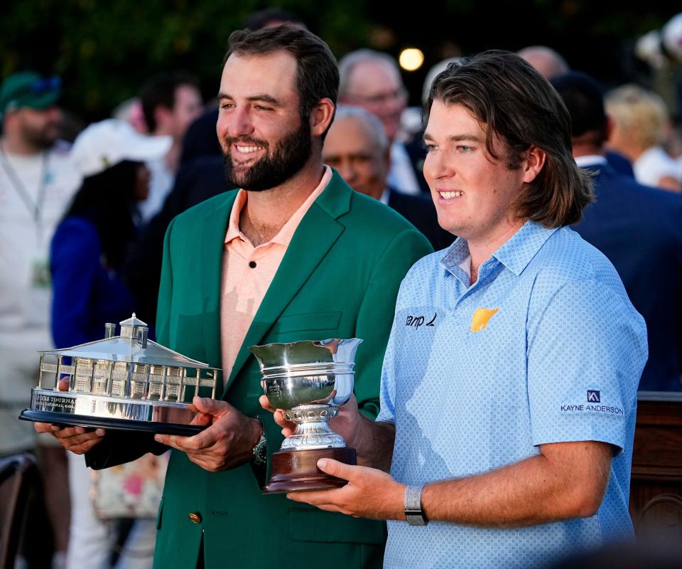 Tournament winner Scottie Scheffler and low amateur Neal Shipley hold their trophies at the green jacket ceremony after the 2024 Masters.