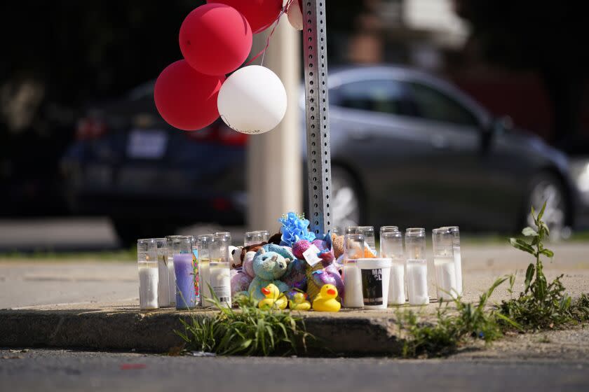 Mementos and candles are seen at a memorial for Dymir Stanton, 29, a victim of a fatal shooting spree, Thursday, July 6, 2023, in Philadelphia. (AP Photo/Matt Slocum)
