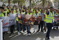 Protesters demonstrate in Martyrs Square in Tripoli, Libya, Friday, July 1, 2022, calling for election and protesting against the government and parliament. The banner reads, “Acceleration of the presidential and parliamentary elections, Immediately." (AP Photo/Yousef Murad)
