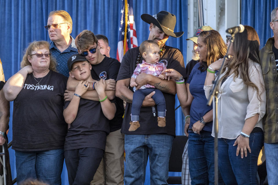 Family members of victims listen to the names of those who lost their lives during the dedication of the Borderline Healing Garden at Conejo Creek Park in Thousand Oaks, Calif., Thursday, Nov. 7, 2019. The dedication marked the anniversary of a fatal mass shooting at a country-western bar a year earlier. (Hans Gutknecht/The Orange County Register via AP)