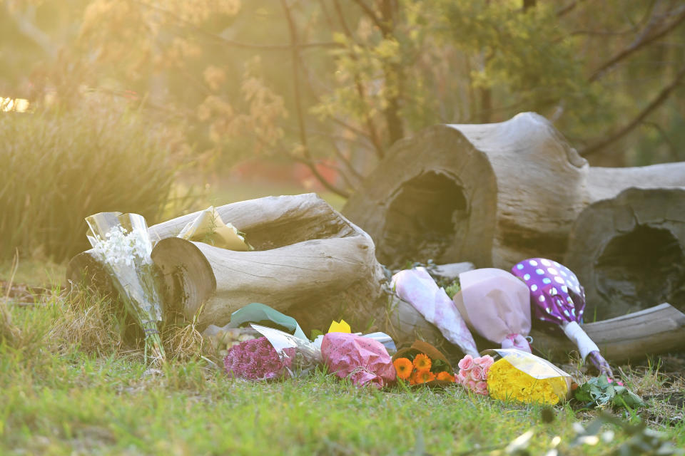 Bunches of flowers at the park for Courtney Herron.