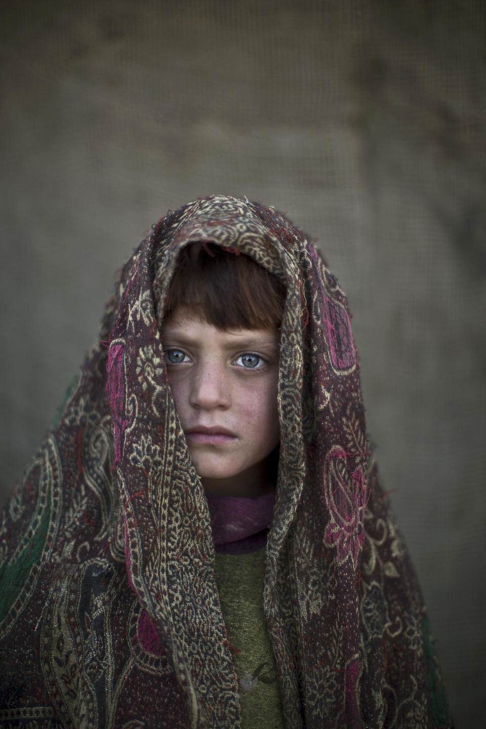 In this Friday, Jan. 24, 2014 photo, Afghan refugee girl, Naseebah Zarghoul, 6, poses for a picture, while playing with other children in a slum on the outskirts of Islamabad, Pakistan. For more than three decades, Pakistan has been home to one of the world’s largest refugee communities: hundreds of thousands of Afghans who have fled the repeated wars and fighting their country has undergone. Since the 2002 U.S.-led invasion of Afghanistan, some 3.8 million Afghans have returned to their home country, according to the U.N.’s refugee agency. (AP Photo/Muhammed Muheisen)