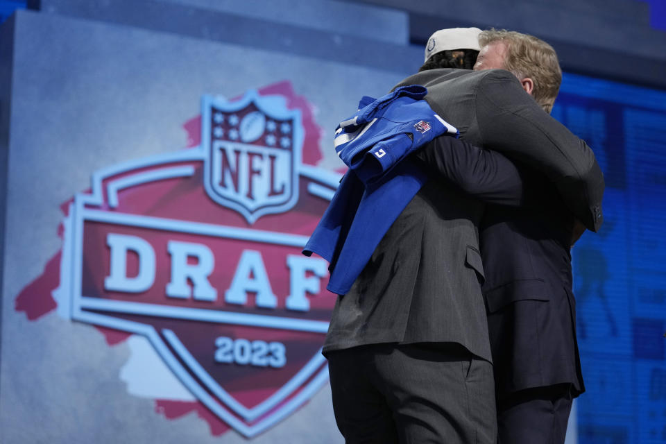 Florida quarterback Anthony Richardson, left, embraces NFL Commissioner Roger Goodell after being chosen by the Indianapolis Colts with the fourth overall pick during the first round of the NFL football draft, Thursday, April 27, 2023, in Kansas City, Mo. (AP Photo/Jeff Roberson)