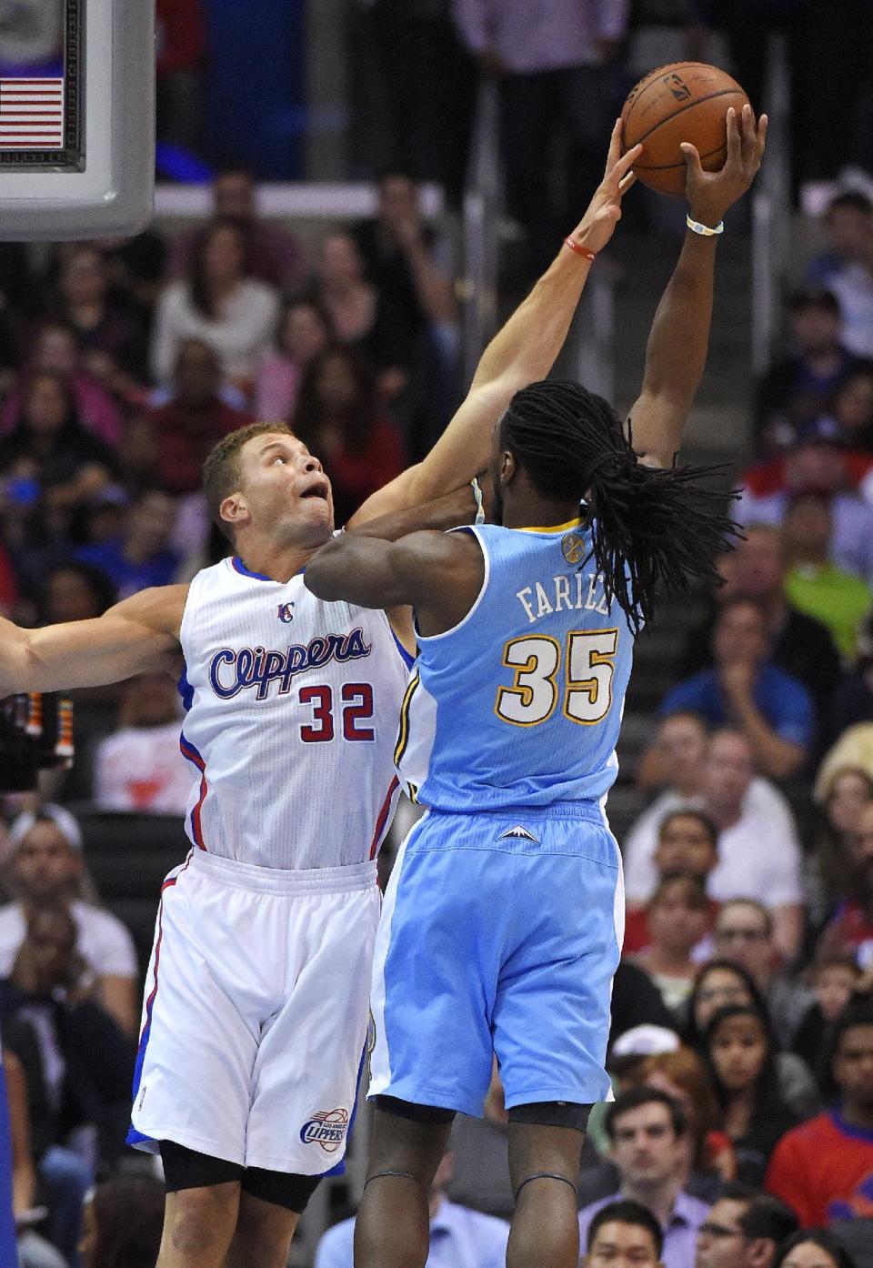 Denver Nuggets forward Kenneth Faried, right, shoots as Los Angeles Clippers forward Blake Griffin defends during the first half of an NBA basketball game, Tuesday, April 15, 2014, in Los Angeles. (AP Photo/Mark J. Terrill)