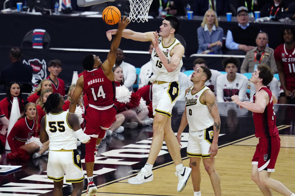 Purdue center Zach Edey (15) blocks the shot of NC State guard Casey Morsell during the second half of the NCAA college basketball game at the Final Four, Saturday, April 6, 2024, in Glendale, Ariz. (AP Photo/Ross D. Franklin)