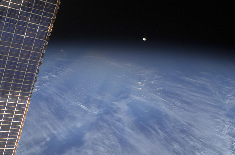 A full moon is visible with part of the International Space Station's solar array wing in this view above Earth's horizon, photographed by a crew member from the International Space Station while Space Shuttle Discovery (STS-128) remains docked with the station in this NASA handout photo taken September 3, 2009. REUTERS/NASA/Handout (UNITED STATES SCI TECH IMAGES OF THE DAY) FOR EDITORIAL USE ONLY. NOT FOR SALE FOR MARKETING OR ADVERTISING CAMPAIGNS