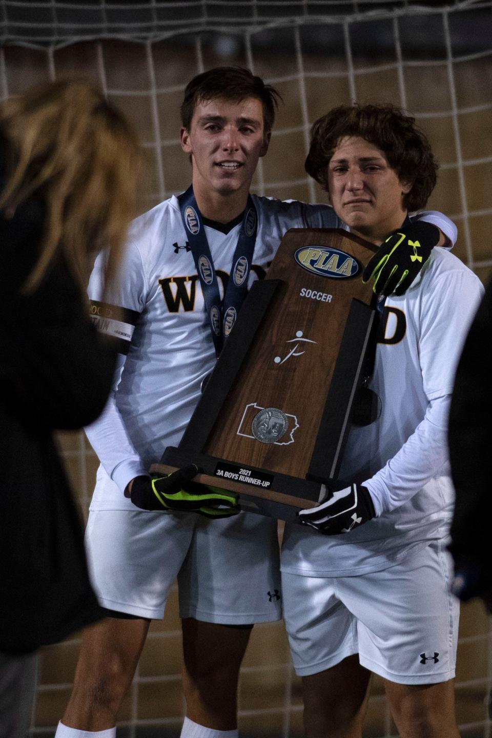 Archbishop Wood senior defender Dom Petruzzelli, left, and sophomore forward Enzo Petruzelli pose for a portrait with the PIAA runner-up trophy after the game at Hersheypark Stadium in Hershey on Saturday, Nov. 20. Archbishop Wood fell to Hampton 1-0 in PIAA boys soccer title game.