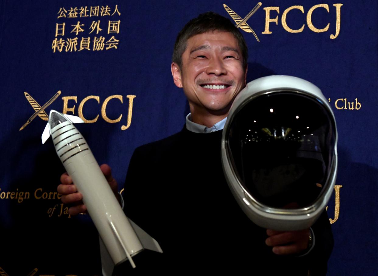 Yusaku Maezawa, entrepreneur and CEO of ZOZOTOWN and SpaceX BFR's first private passenger, poses with a miniature rocket and space helmet prior to start of a press conference at the Foreign Correspondents' Club of Japan in Tokyo on October 9, 2018.  Photo: TOSHIFUMI KITAMURA/AFP via Getty Images