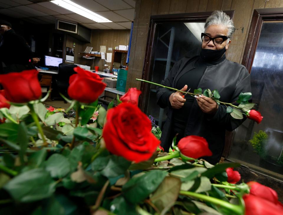 Lisa McCoy, 60, of Detroit, works on arranging a casket spray for a customer on Thursday, Feb. 2, 2023 at Brazelton Floral, where she has been a florist for the past three years. Alice Brazelton-Pittman, the owner of floral company, took over the business from her father Ed Brazelton who started it in the early 1940s in the same location, a house on West Grand Boulevard near the Motown Museum.