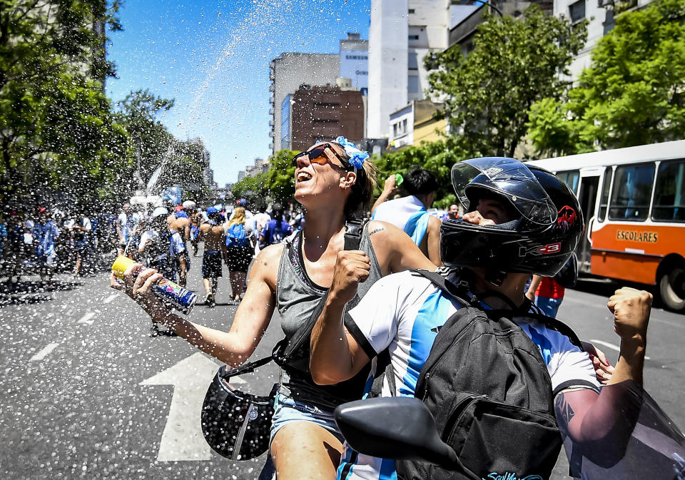 BUENOS AIRES, ARGENTINA - DECEMBER 20: Fans of Argentina on a motorbike celebrate with carnival foam as they gather for the victory parade of the Argentina men's national football team after winning the FIFA World Cup Qatar 2022 on December 20, 2022 in Buenos Aires, Argentina. (Photo by Marcelo Endelli/Getty Images)