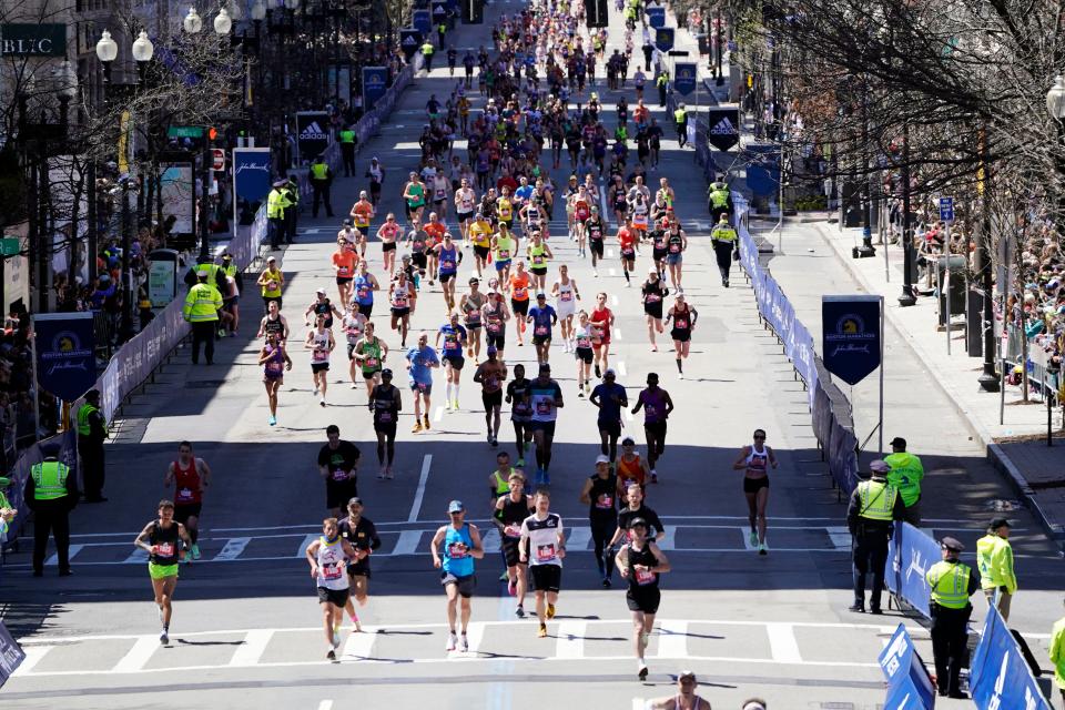 Runners approach the finish line of the Boston Marathon on April 18, 2022.