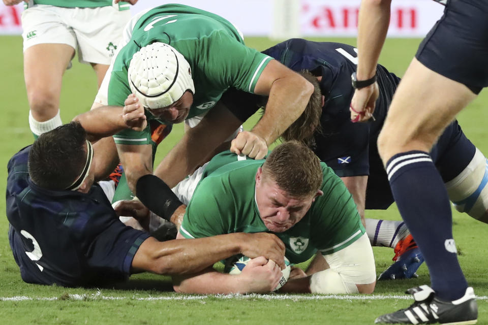 Ireland's Tadhg Furlong, center, carries a ball to score the teams' third try during the Rugby World Cup Pool A game at International Stadium between Ireland and Scotland in Yokohama, Japan, Sunday, Sept. 22, 2019. (AP Photo/Eugene Hoshiko)