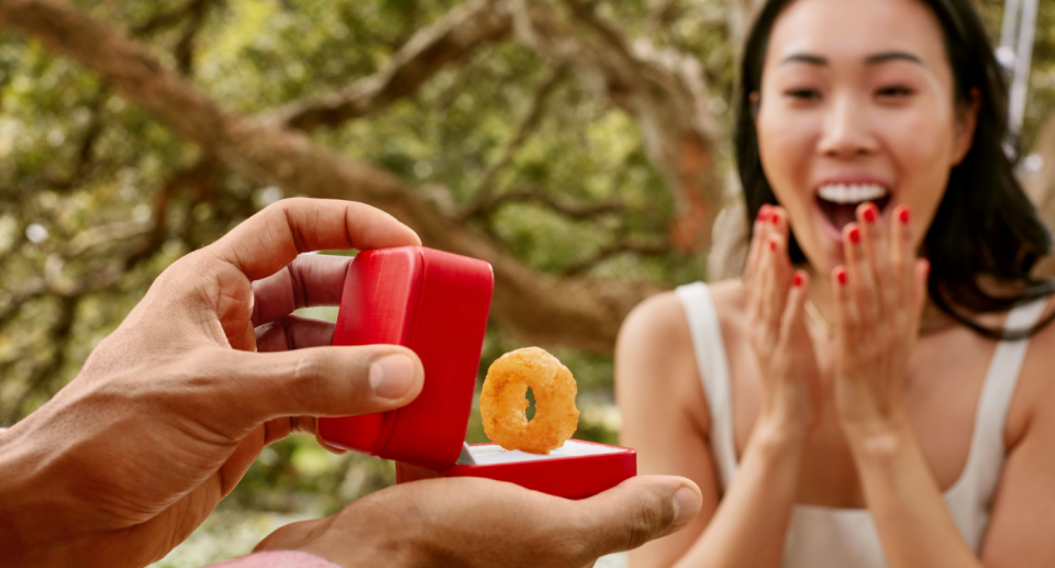 Woman being proposed to with KFC onion ring