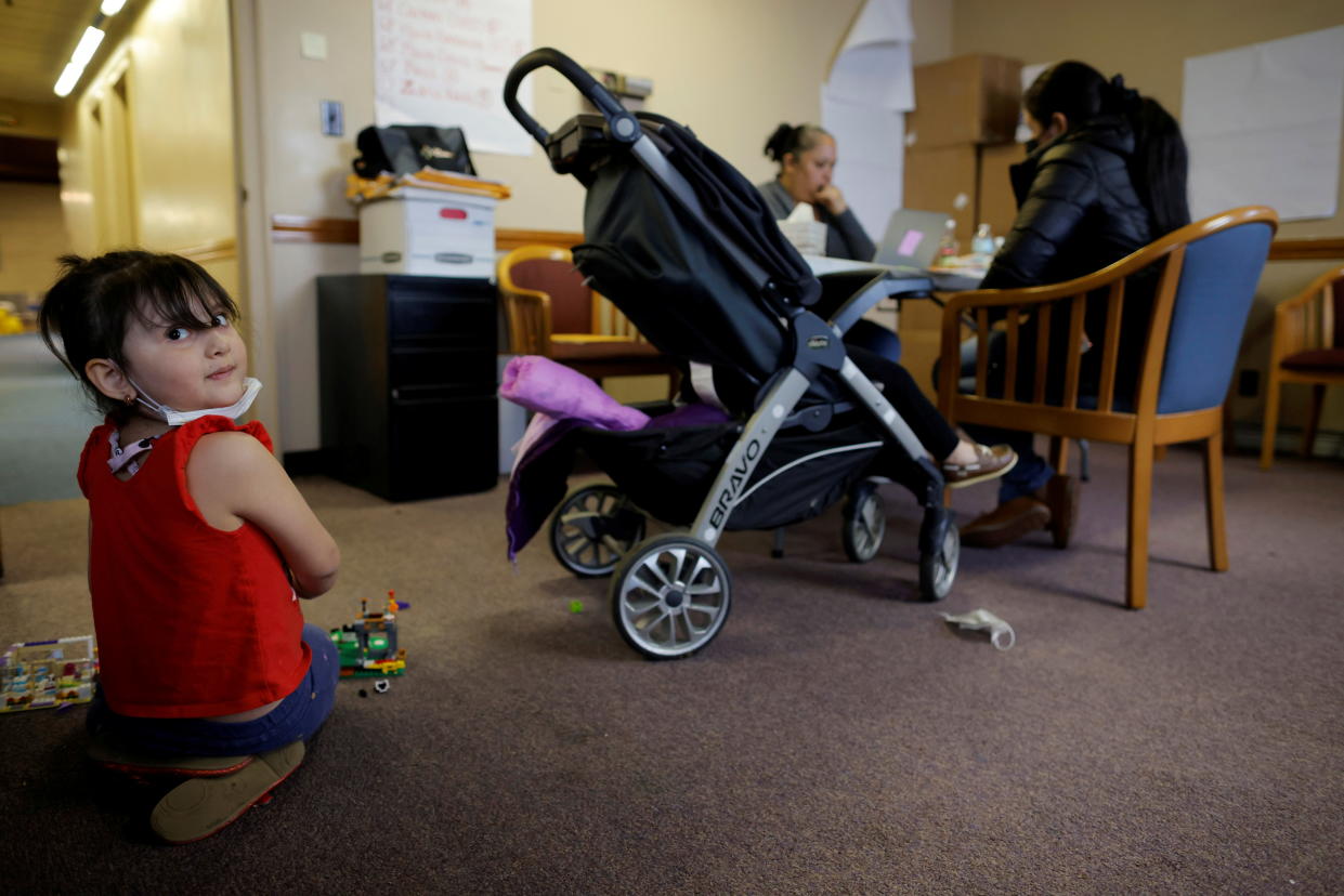 Five year-old Lucia plays with toys while Elizabeth Dejesus helps her mother apply for rental payment assistance at La Colaborativa, which offers housing and rental assistance amid the coronavirus disease (COVID-19) pandemic, in Chelsea, Massachusetts, U.S., May 4, 2021.    REUTERS/Brian Snyder     TPX IMAGES OF THE DAY