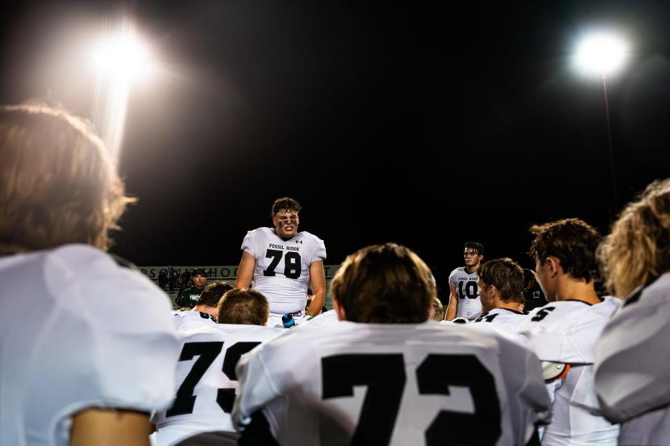 Gage Ginther (78) of the Fossil Ridge Sabercats speaks to his team after the season opener against the Loveland Red Wolves at Ray Patterson Field in Loveland on Friday, Aug. 25, 2023. Fossil Ridge lost 28-26.