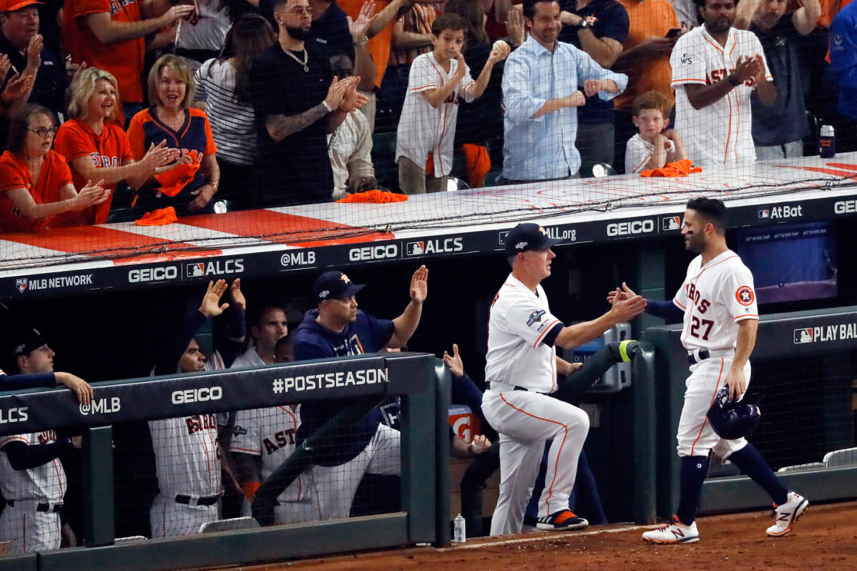  Jose Altuve is greeted at the dugout manager AJ Hinch (Sue Ogrocki / AP file)