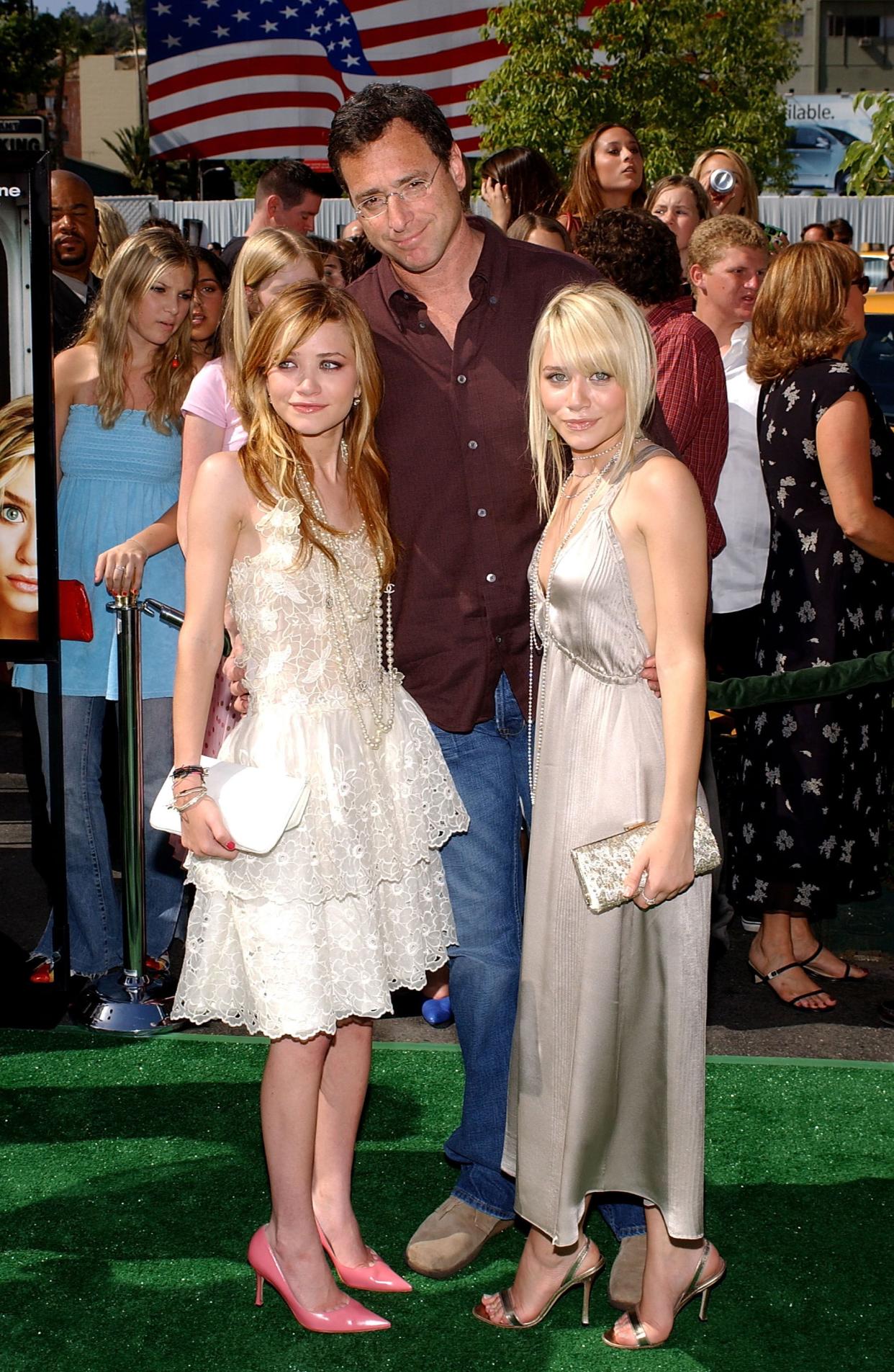 Actors Mary-Kate Olsen, Bob Saget and Ashley Olsen attend the Los Angeles premiere of the Warner Brothers film "New York Minute" on May 1, 2004, at the Grauman's Chinese Theatre in Hollywood, Calif.