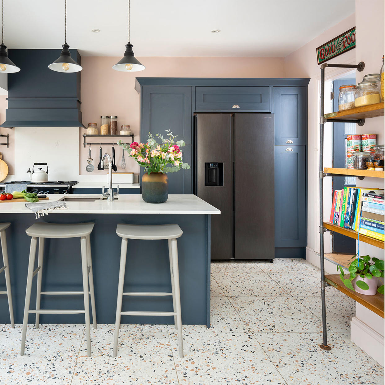  Blue kitchen with island and shelving. 