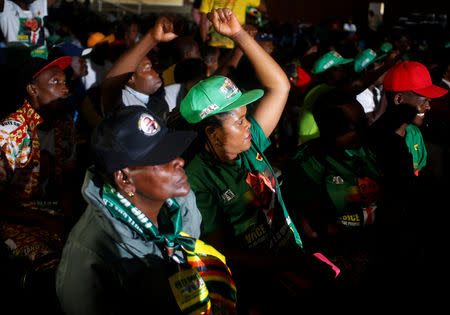 Supporters of President Emmerson Mnangagwa's ruling ZANU-PF party react to the results of a constitutional court hearing, challenging his electoral victory in Harare, Zimbabwe August 24, 2018. REUTERS/Philimon Bulawayo