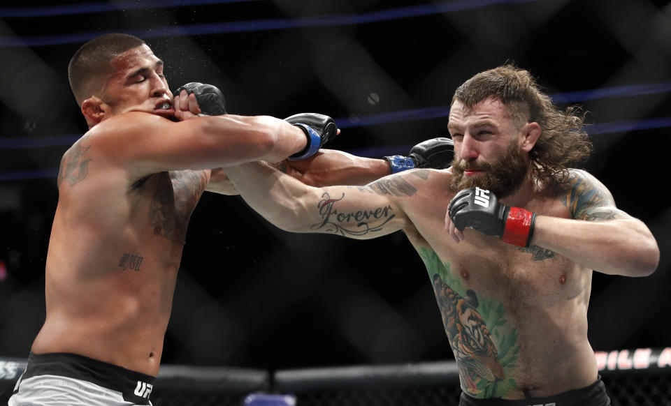 Michael Chiesa hits Anthony Pettis during a lightweight mixed martial arts bout at UFC 226, Saturday, July 7, 2018, in Las Vegas. (AP Photo/John Locher)