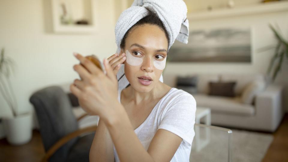 attractive young woman having her own spa treatment at home