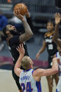 Cleveland Cavaliers' Andre Drummond, left, shoots over Detroit Pistons' Mason Plumlee in the first half of an NBA basketball game, Wednesday, Jan. 27, 2021, in Cleveland. (AP Photo/Tony Dejak)