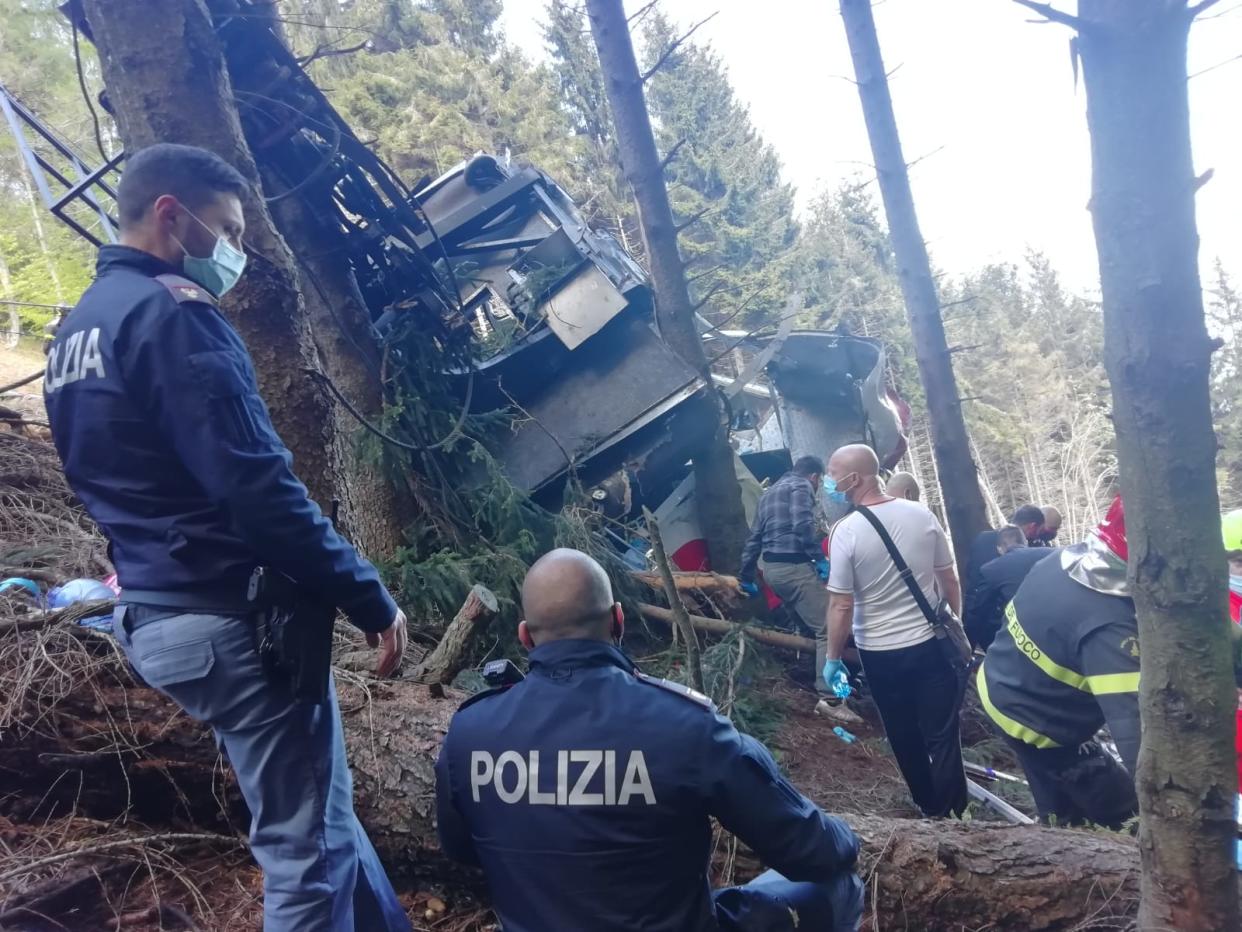 STRESA, ITALY - MAY 23: In this handout photo provided by the Italian state police, emergency workers surround the wreckage of a cable car that fell from the Stresa-Alpine-Mottarone line on May 23, 2021 in Stresa, Italy. The accident happened on a service that takes passengers from the resort town Stresa, up Mottarone mountain, in the Piedmont region. Italian news outlets reported that 11 people had been riding in the cable car before it fell, and officials said that two children were taken from the accident site to a hospital in Turin. (Handout photo by the Italian State Police via Getty Images)