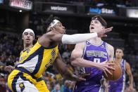 Sacramento Kings' Kevin Huerter (9) goes to the basket against Indiana Pacers' Buddy Hield (24) during the first half of an NBA basketball game, Friday, Feb. 3, 2023, in Indianapolis. (AP Photo/Darron Cummings)