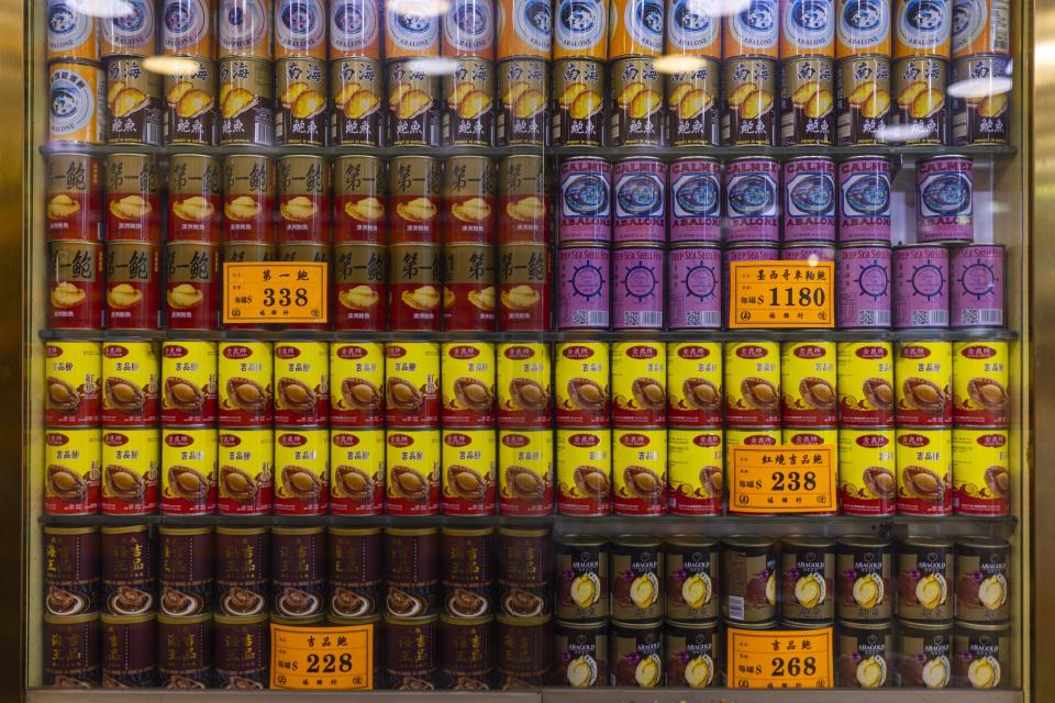 Cans of abalones, including abalone from South Africa, are displayed for sale at a shop in Hong Kong, Wednesday, April 12, 2023. Abalone is a sign of prestige or something you would give as a gift in Hong Kong. (AP Photo/Louise Delmotte)