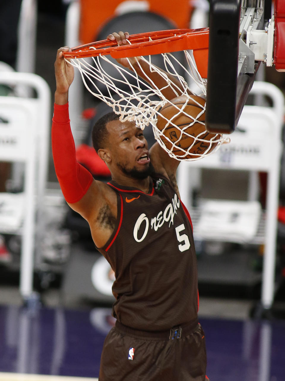 Portland Trail Blazers' Rodney Hood slams the ball home after stealing the ball during the first half of an NBA basketball game Monday, Feb. 22, 2021, in Phoenix. (AP Photo/Darryl Webb)