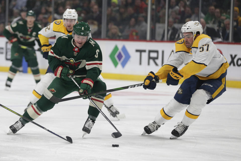 FILE - In this March 3, 2020, file photo, Minnesota Wild's Ryan Donato (38) controls the puck under pressure from Nashville Predators defenseman Dante Fabbro (57) during the first period of an NHL hockey game in St. Paul, Minn. The Wild have traded Donato to the San Jose Sharks for a third-round pick in the 2021 draft. Donato will give the Sharks some additional depth on the wing. (AP Photo/Andy Clayton-King, File)