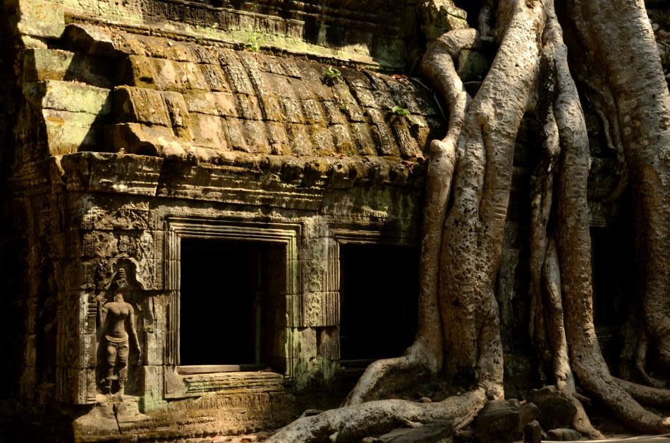 You would probably remember this temple for the Angelina Jolie film Tomb Raider. As I walked around Ta Prohm, it was amidst a restoration process assisted by the Indian government. The trees, their long serpentine roots and sturdy trunks, beckon you here. The eyes follow them as they mysteriously curl around a boulder and add an element of wildness to a sculpture. It was believed to have been a temple monastery. Ta Prohm leaves you breathless as you watch the elements of nature and art create wild magic in front of you.