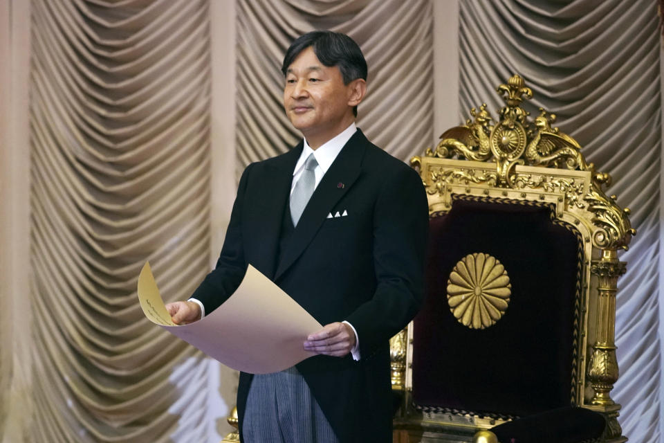 Japan's Emperor Naruhito reads a statement to open formally an extraordinary session at the upper house of parliament in Tokyo Thursday, Aug. 1, 2019. Naruhito delivered his first opening speech since ascending to the Chrysanthemum Throne on May 1. (AP Photo/Eugene Hoshiko)