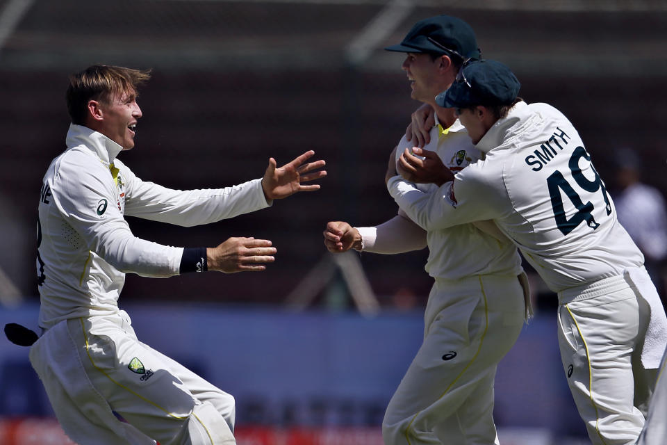Australia's Mitchell Swepson, center, celebrates with teammates after the dismissal of Pakistan's Abdullah Shafique during the third day of the second test match between Pakistan and Australia at the National Stadium in Karachi, Pakistan, Monday, March 14, 2022. (AP Photo/Anjum Naveed)