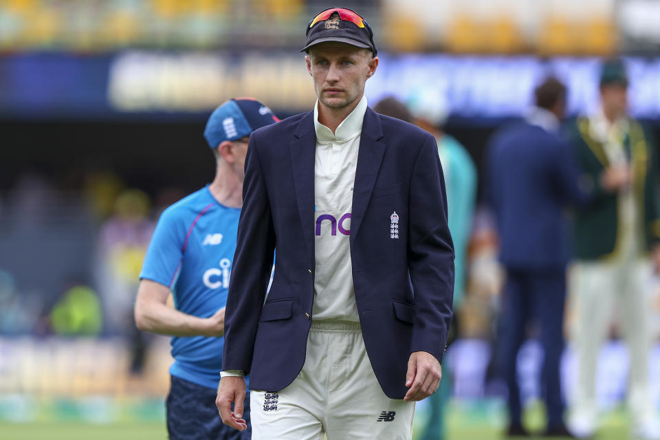 England captain Joe Root walks from the field ahead of play on day one of the first Ashes cricket test, against Australia, at the Gabba in Brisbane, Australia, Wednesday, Dec. 8, 2021. (AP Photo/Tertius Pickard)