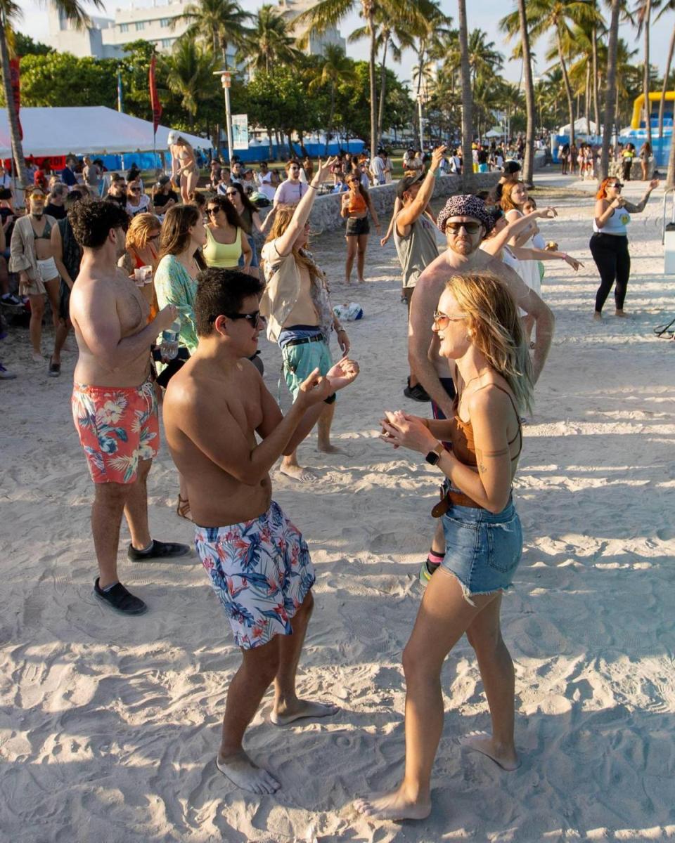 People dance during a concert for Art on the Drive, a Carnaval Miami event, off Ocean Drive during Spring Break in Miami Beach, Florida, on Saturday, March 18, 2023.