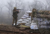 A Ukrainian soldier takes position on the front line at the town of Novoluhanske in the Donetsk region, Ukraine, Monday, Dec. 9, 2019. A long-awaited summit in Paris on Monday aims to find a way to end the war in eastern Ukraine, a conflict that after five years and 14,000 lives lost has emboldened the Kremlin and reshaped European geopolitics. (AP Photo/Vitali Komar)