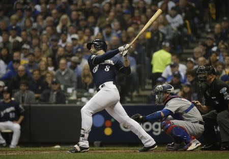 Oct 12, 2018; Milwaukee, WI, USA; Milwaukee Brewers left fielder Ryan Braun (8) hits an RBI single during the fourth inning against the Los Angeles Dodgers in game one of the 2018 NLCS playoff baseball series at Miller Park. Mandatory Credit: Jon Durr-USA TODAY Sports