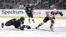 Los Angeles Kings center Anze Kopitar, left, dives for the puck as Anaheim Ducks center Adam Henrique, right, reaches for it during the second period of an NHL hockey game Tuesday, Nov. 30, 2021, in Los Angeles. (AP Photo/Mark J. Terrill)