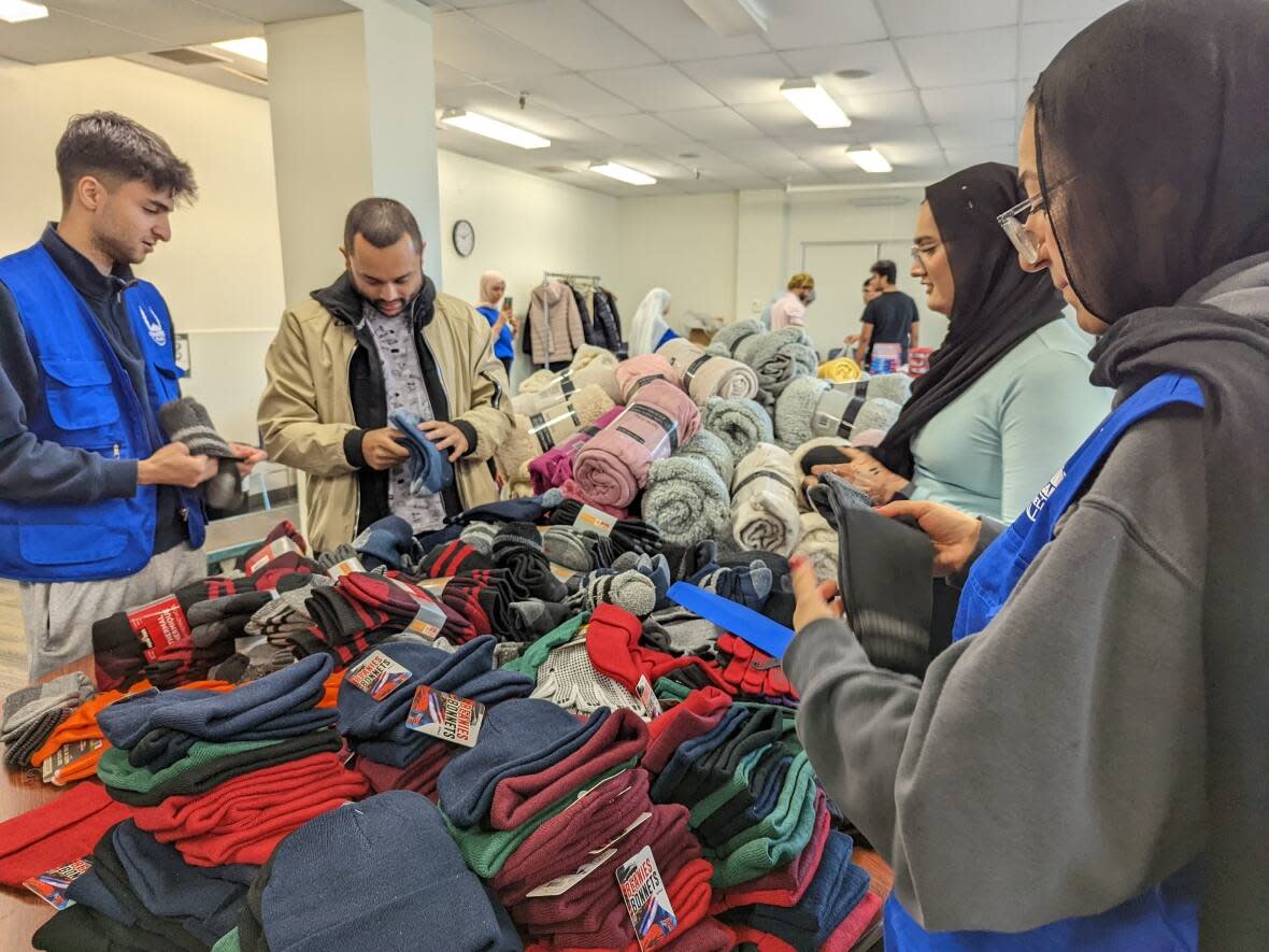 Islamic Relief Canada volunteers came together in Halifax on Sunday to assemble winter relief kits for people in need. (Victoria Welland/CBC - image credit)