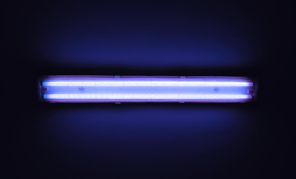 Detail shot of a fluorescent light tube on a wall with copyspace.