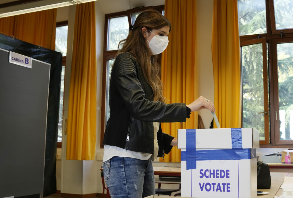A woman casts her ballot for the abortion referendum at a polling station in San Marino, Sunday, Sept. 26, 2021. Tiny San Marino is one of the last countries in Europe which forbids abortion in any circumstance — a ban that dates from 1865. Its citizens are voting Sunday in a referendum calling for abortion to be made legal in the first 12 weeks of pregnancy. (AP Photo/Antonio Calanni)