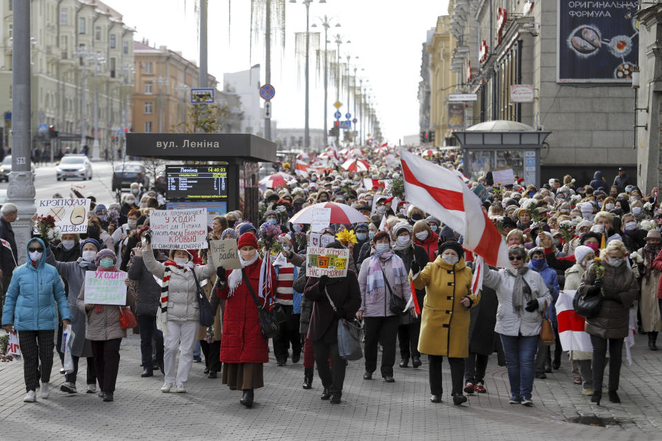 People, most of them elderly women, walk during an opposition rally in Minsk, Belarus, Monday, Oct. 19, 2020. The elderly rallied in Minsk once again on Monday to demand resignation of the country's President Alexander Lukashenko, as mass protests triggered by a disputed election continue to rock Belarus. Lukashenko's older supporters also gathered in the country's capital Monday for a pro-government rally. (AP Photo)