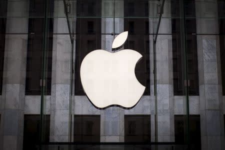 An Apple logo hangs above the entrance to the Apple store on 5th Avenue in New York City, in this file photo taken July 21, 2015. REUTERS/Mike Segar