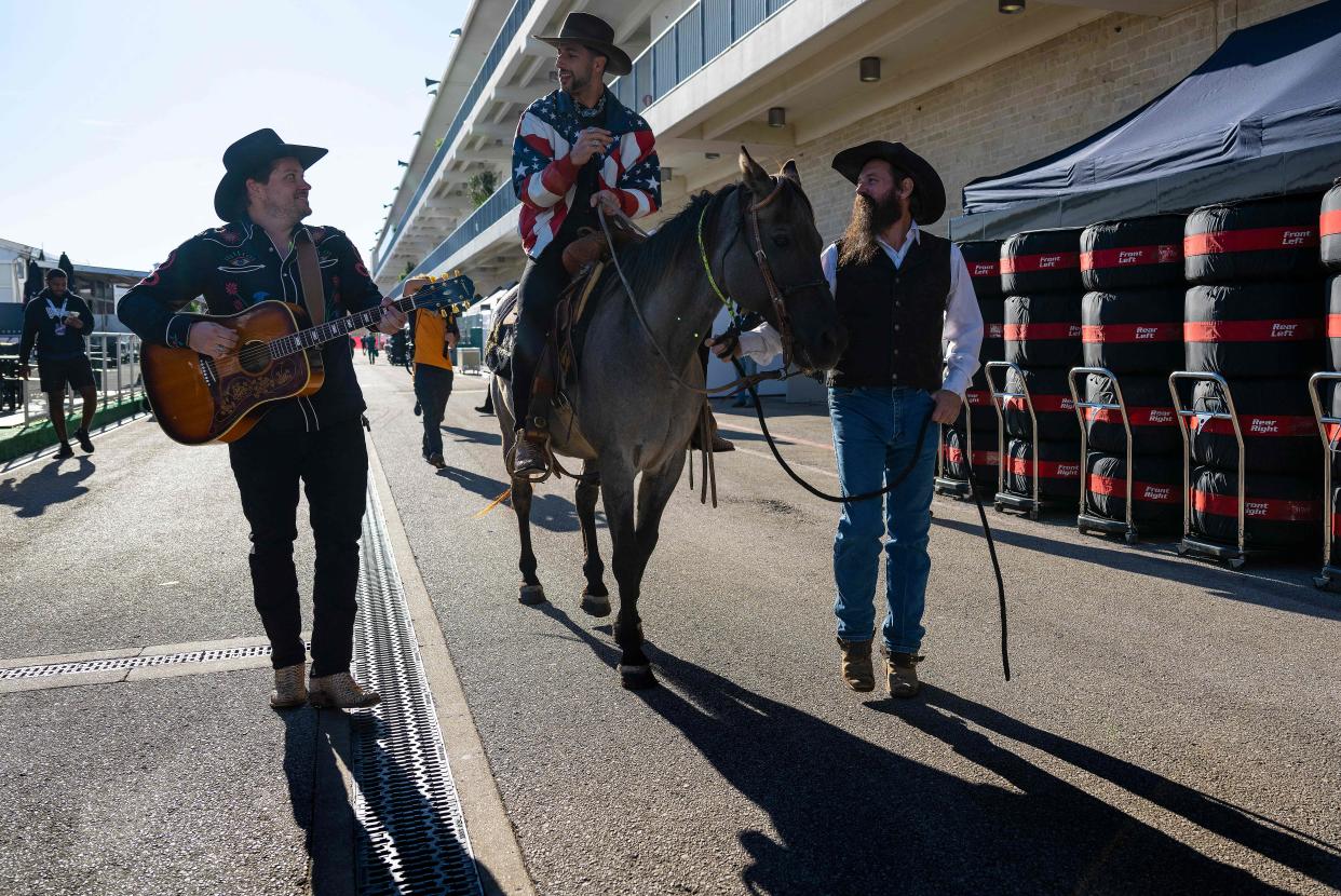 McLarens Australian driver Daniel Ricciardo arrives in the paddock on horseback during the Formula One United States Grand Prix preview day, at the Circuit of the Americas in Austin, Texas, on October 20, 2022. (Photo by Jim WATSON / AFP) (Photo by JIM WATSON/AFP via Getty Images)